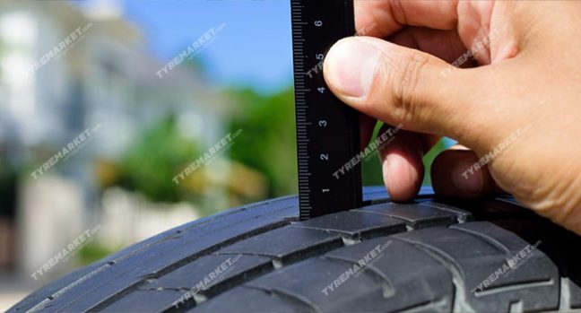 Inspect the depth of tread of a tyre